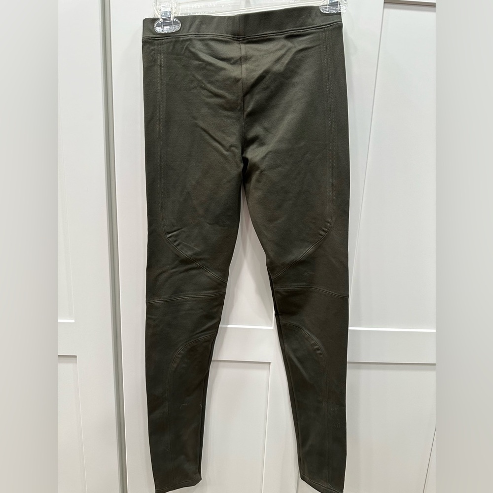Army green fitted pants with zippers at ankles